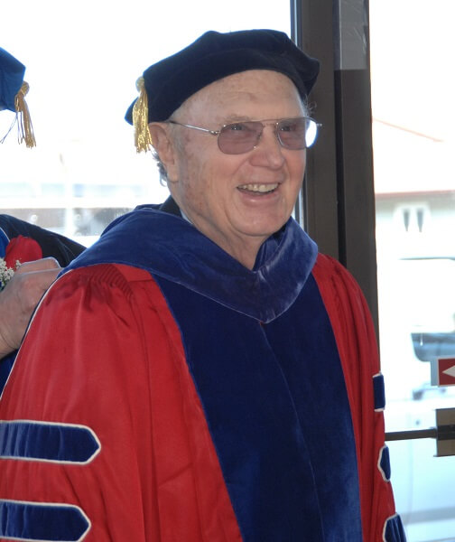 Gil Bane in doctoral robes
